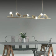 Modern brass-colored metal island lamp with adjustable spotlight heads and maximum bulb wattage for dining room use