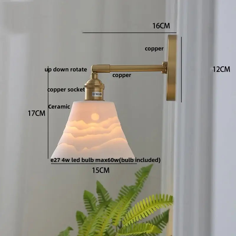 Modern brass mountain led wall lamp sconce with copper finish and ceramic shade embossed with sunrise and cloud design