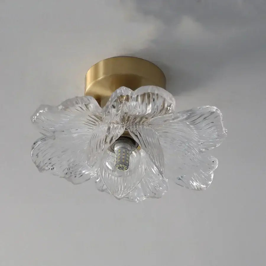 Modern brass orchid glass led ceiling lamp with clear flower-shaped glass and gold-toned metal base for bedroom