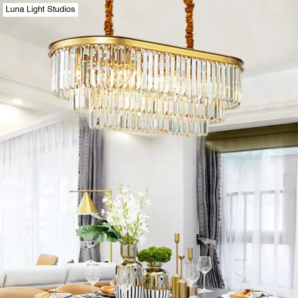 Modern brass oval crystal chandelier with gold frame and cascading prisms for elegant dining room hanging light