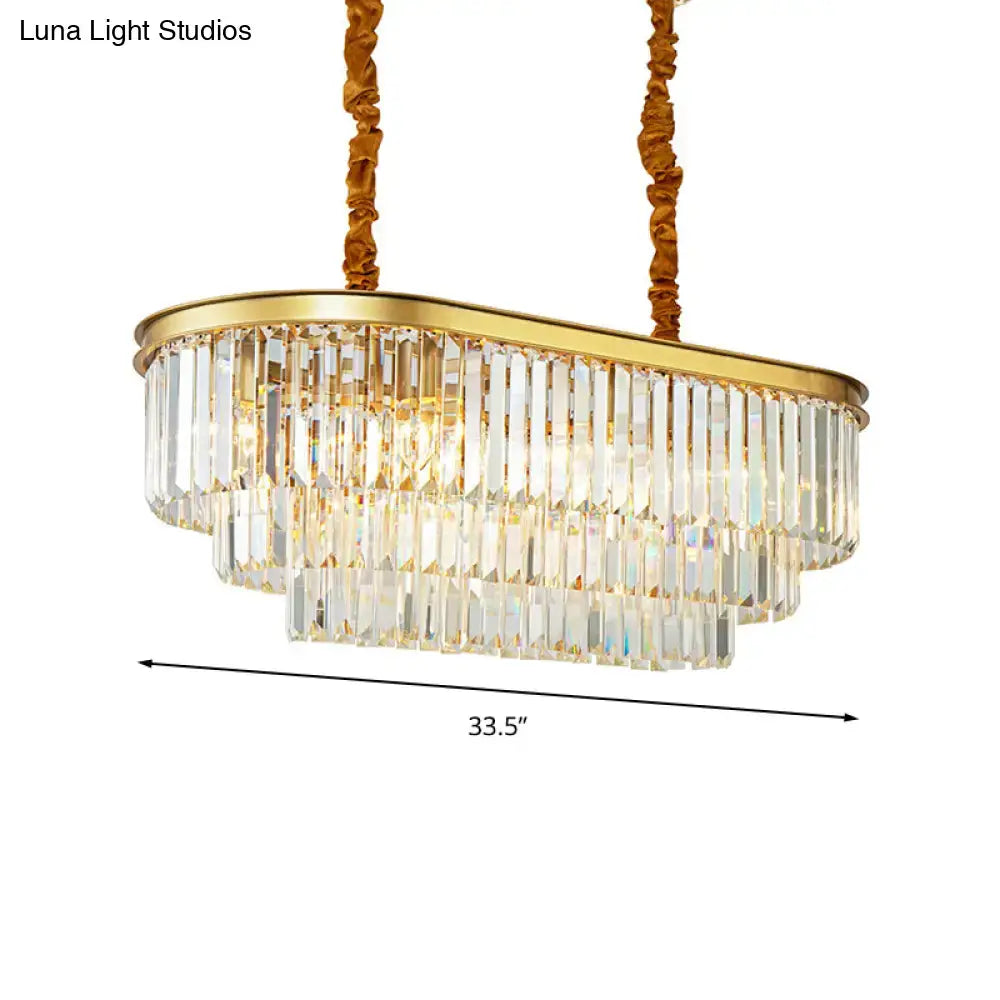 Modern brass oval crystal chandelier with gold tone and clear prisms for elegant dining room hanging light design
