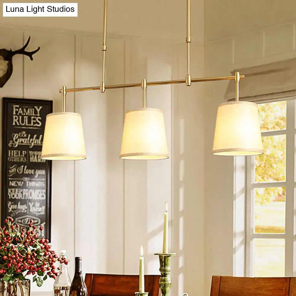 Modern brass pendant light with brass finish and cream white green flaxen fabric shades for dining room lighting