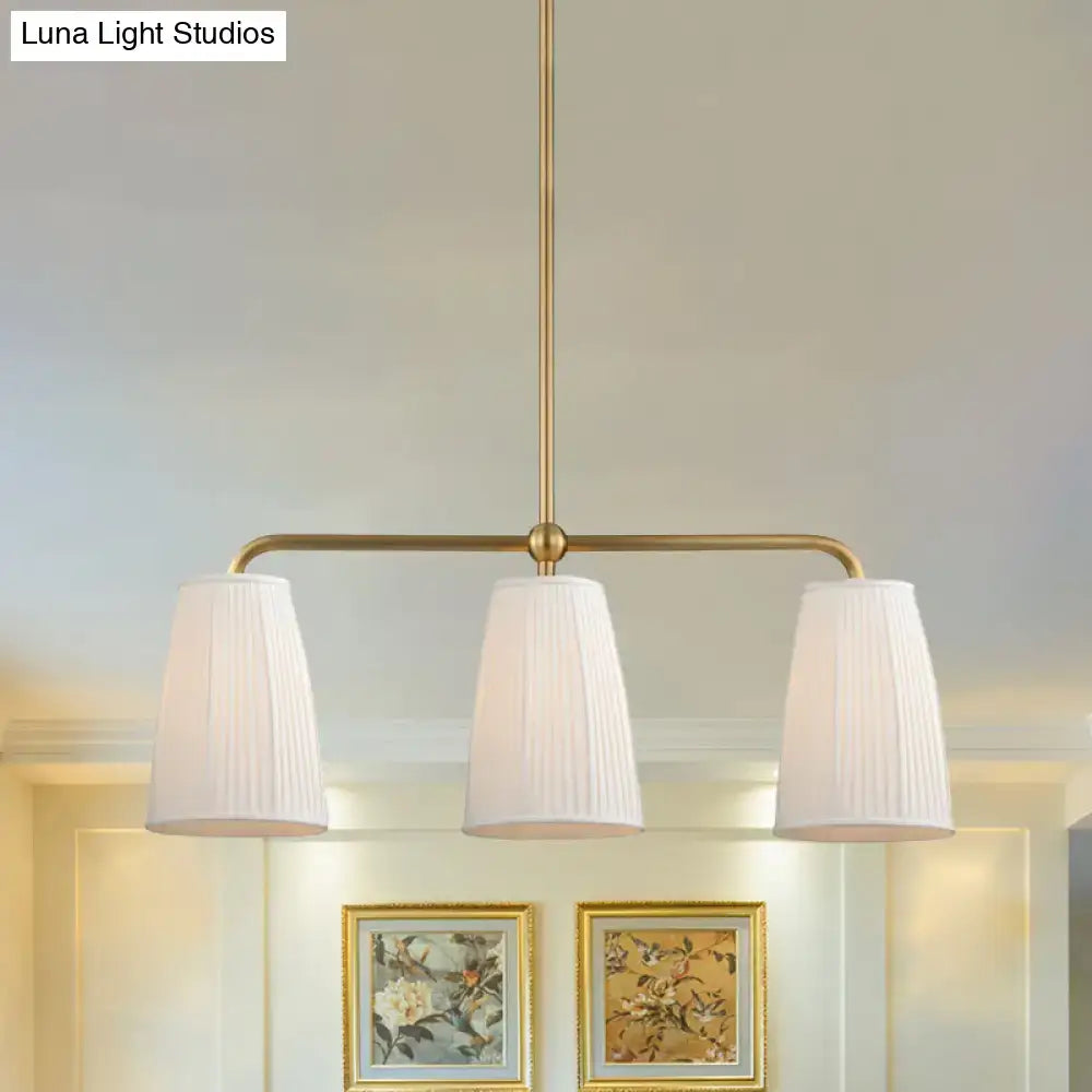 Brass-finished DecorBites rustic pleated fabric pendant chandelier with three white pleated fabric shades for dining table