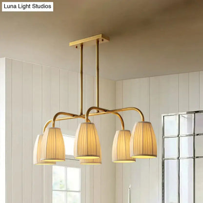 Brass-finished DecorBites rustic pleated fabric pendant chandelier with four warm-toned gold fabric shades for dining table