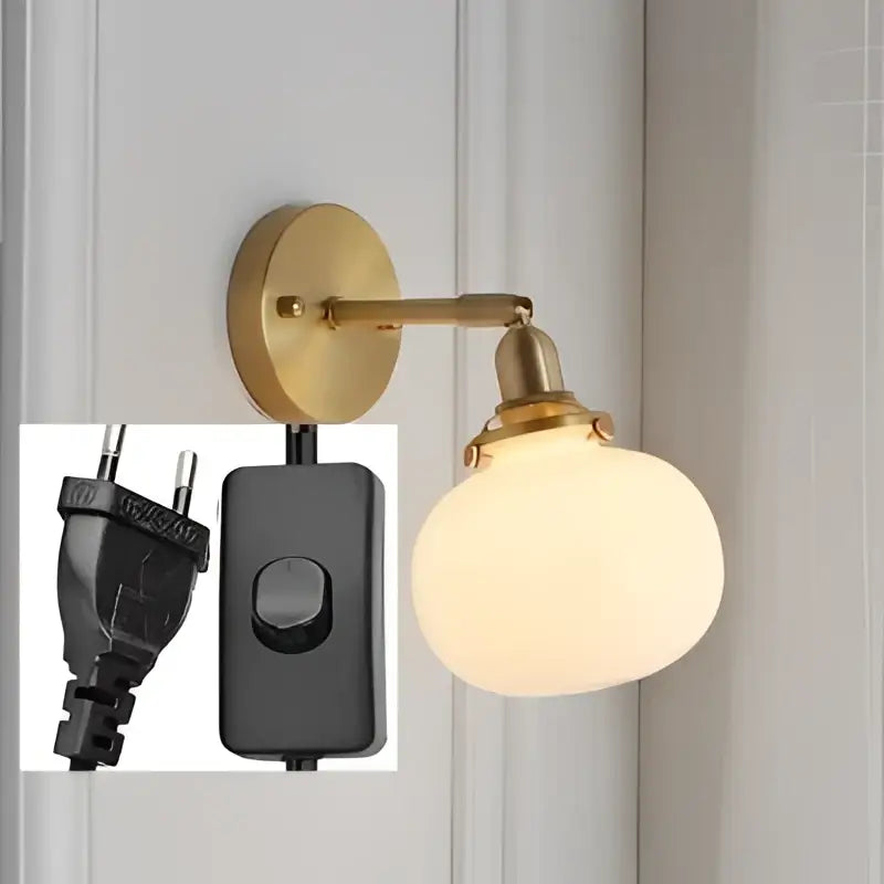 Brass-finished wall sconce with a frosted ribbed glass ball globe for modern decorbites glass ball wall lighting