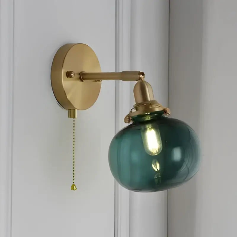 Modern brass ribbed glass ball wall sconce with teal decorbites glass ball and pull chain for bedroom lighting