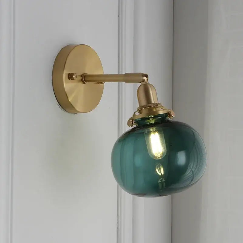 Modern brass ribbed glass ball wall sconce with teal-green glass globe and brass metal arm for bedroom decorbites glass ball