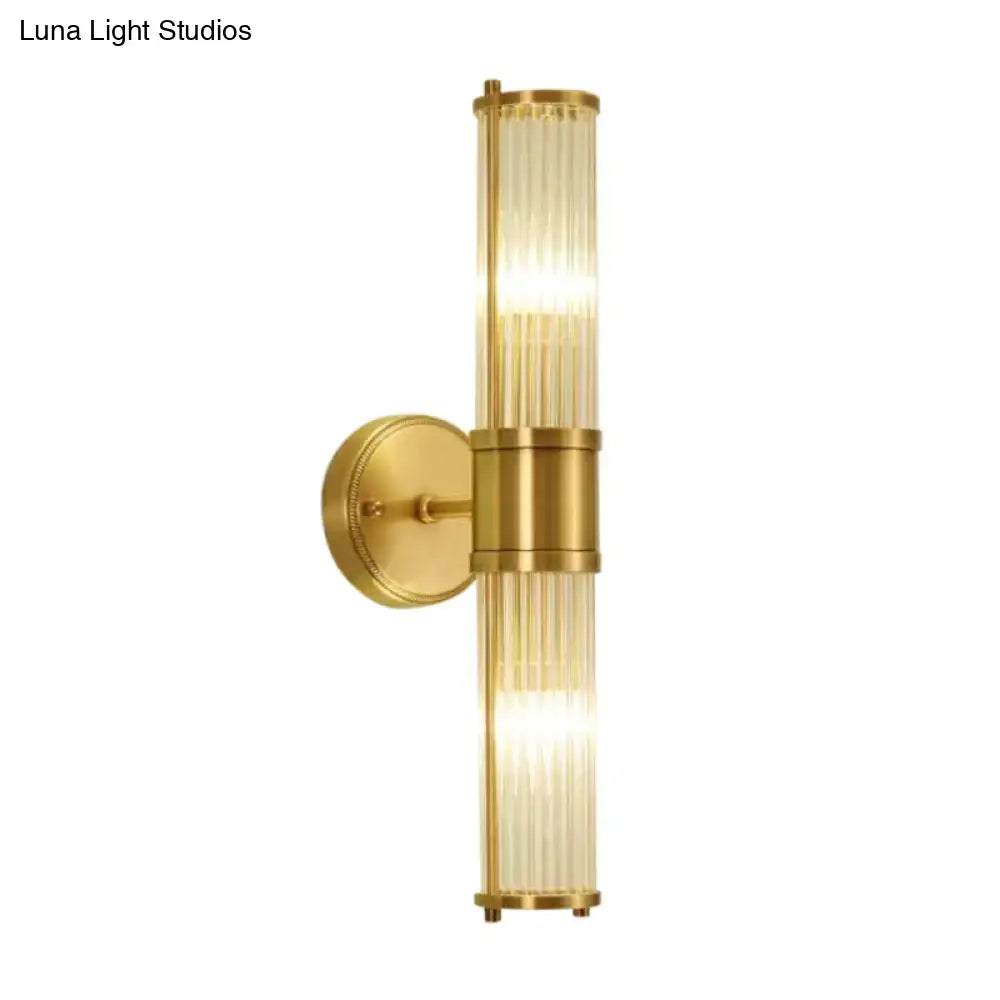 Modern brass ridged crystal wall light with gold-toned vertical ribbed glass panels and sleek fixture height design