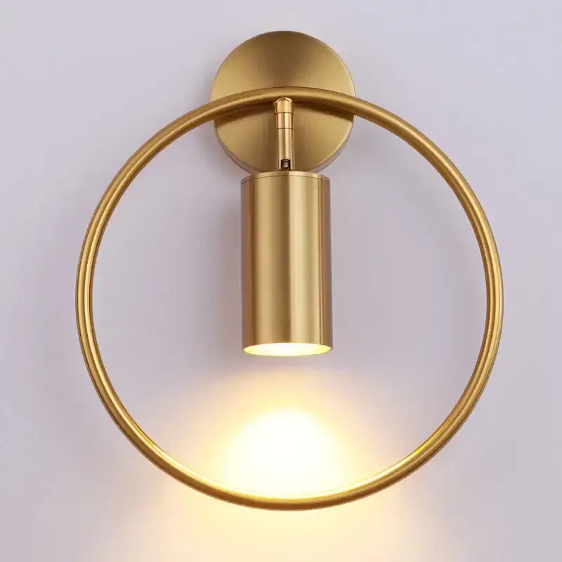 Modern brass ring led wall lamp featuring a gold-finished circular sconce with a minimalist cylindrical light fixture