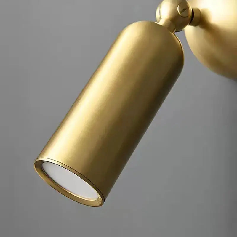 Modern brass rotatable led wall sconces featuring a gold-finished cylindrical spotlight with a matte metallic finish
