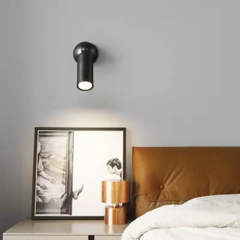 Modern brass rotatable led wall sconces featuring a black cylindrical matte spotlight with adjustable head for decorbites