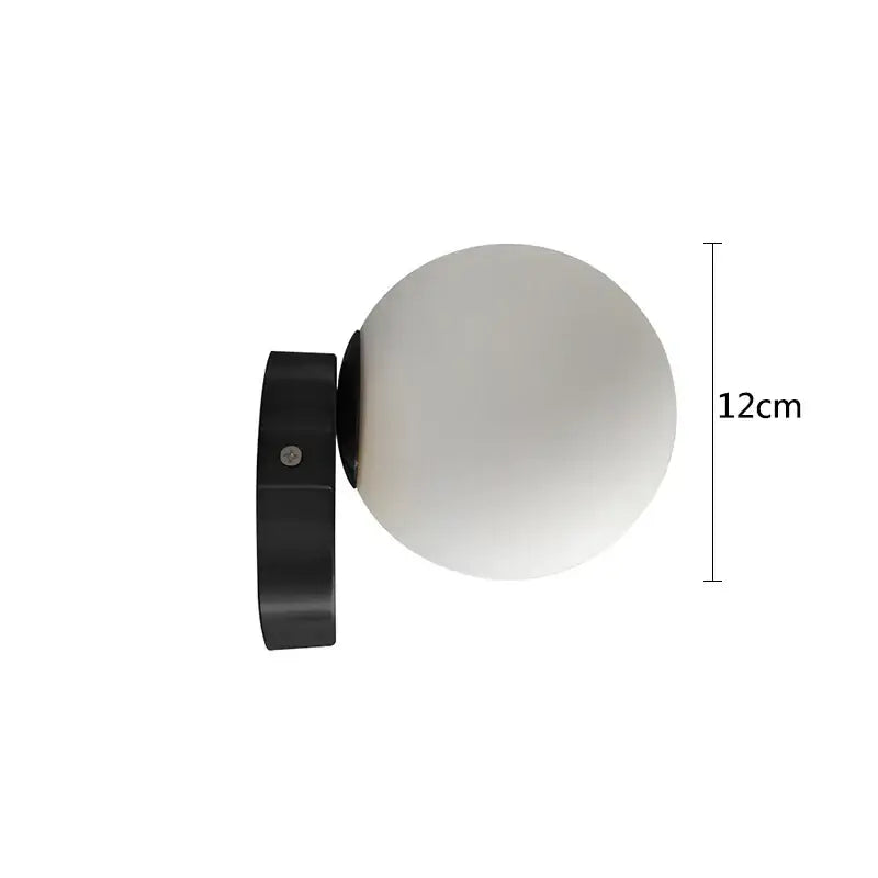 Black wall-mounted spherical lamp with frosted glass globe complementing modern brass glass round ceiling design