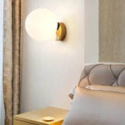Gold-toned modern brass round ceiling lamp with glass round frosted globe for hallway lighting