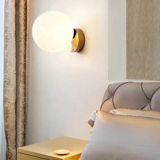 Gold-toned modern brass round ceiling lamp with glass round frosted globe for hallway lighting
