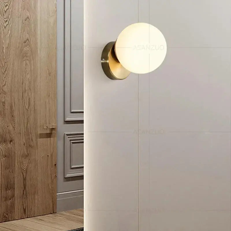 Gold-toned modern brass round ceiling lamp with frosted glass globe for hallway featuring glass round ceiling design