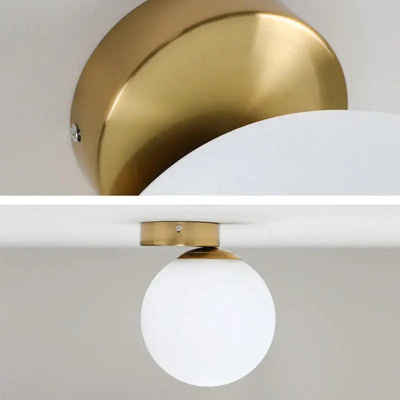 Modern brass round ceiling lamp with gold-finished base and frosted glass round ceiling globe shade for hallway lighting