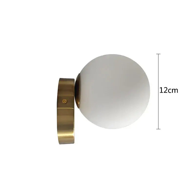 A sleek modern brass round ceiling lamp with a frosted white glass round globe for hallway lighting