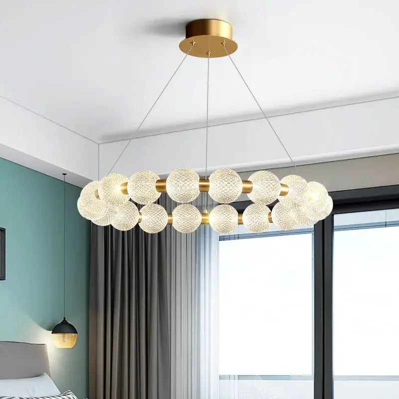 Modern brass round led pendant lights feature a gold-toned chandelier with frosted glass spheres for dining room decorbites brass round