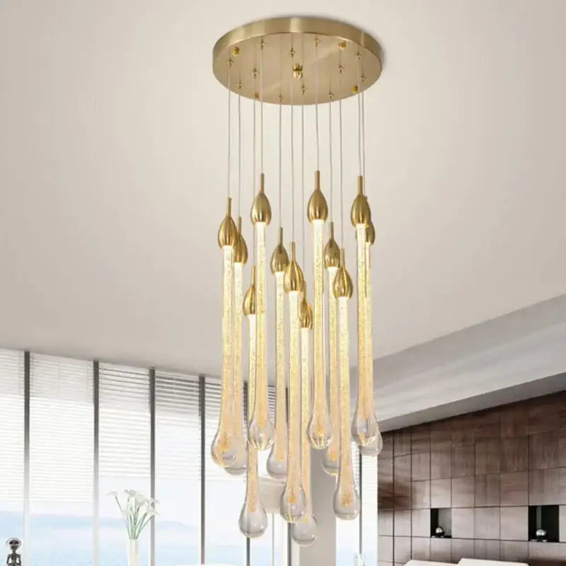 A modern brass round stairs LED chandelier with gold-toned pendant and clear glass teardrop elements for villa dining room decorbites 3w round
