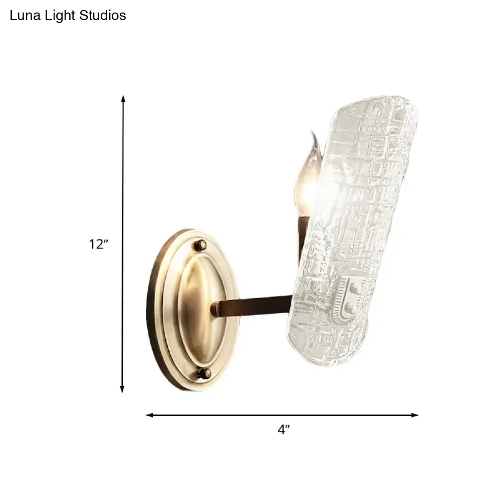 Modern brass sconce with two lights and clear water glass shade featuring intricate circuit board design for living room