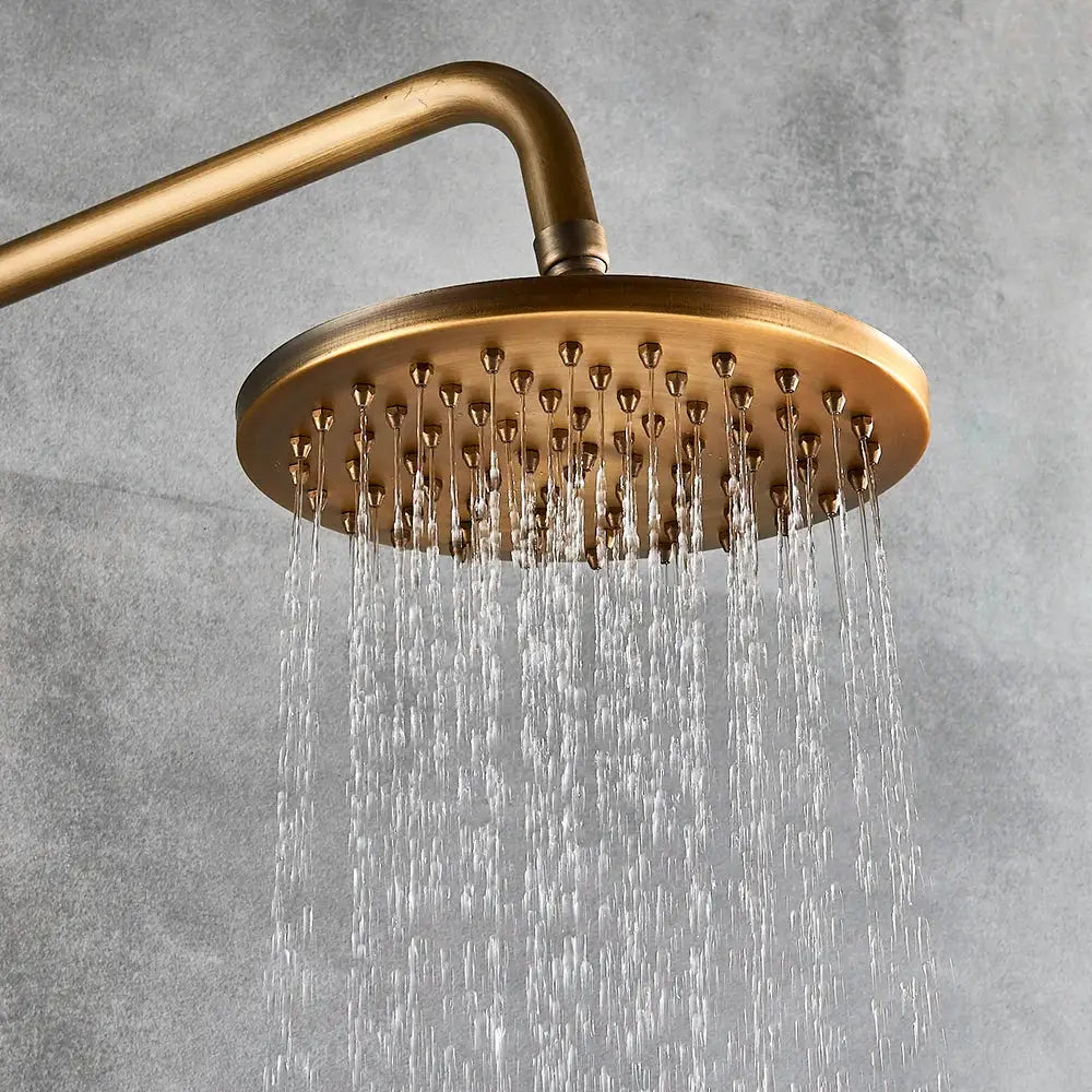 Modern brass shower set featuring a round brass shower head with multiple water jets for bathroom rainfall use
