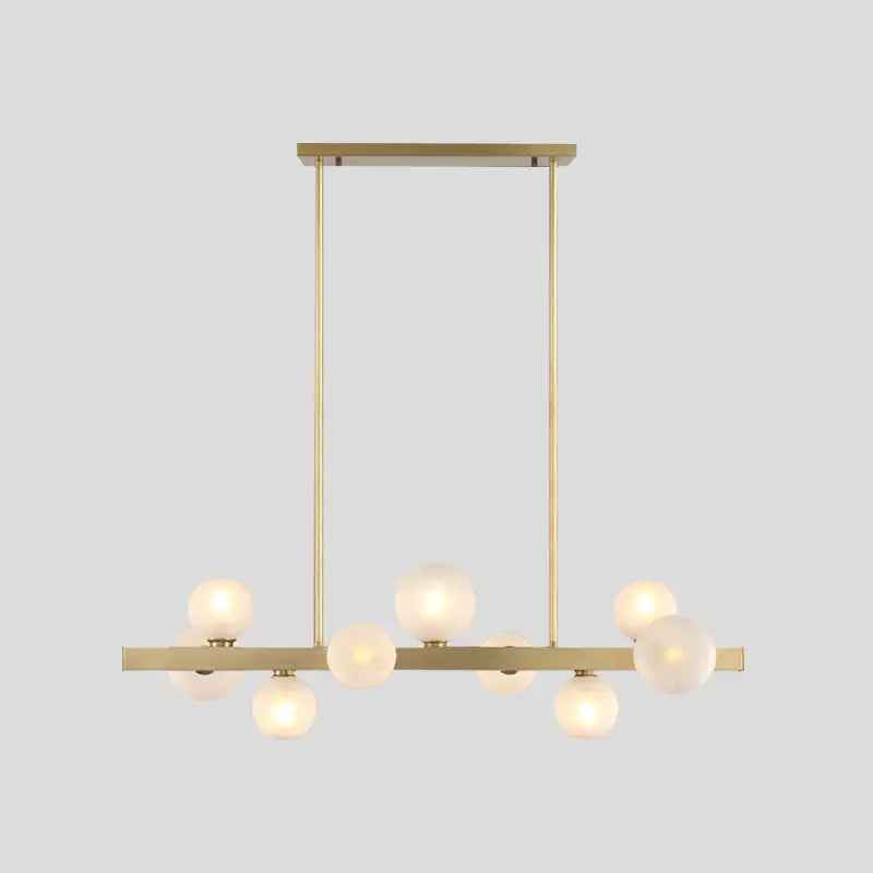 Modern brass simplicity globe pendant with frosted glass bulbs ideal for dining room lighting fixtures