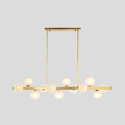 Modern brass simplicity globe pendant dining room light with gold-toned frame and frosted glass globe bulbs in linear design