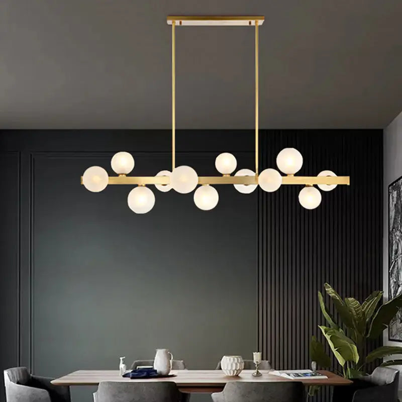 Modern brass simplicity globe pendant dining room light with gold-toned horizontal bar and frosted glass bulbs