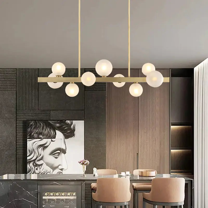 Modern brass simplicity globe pendant featuring frosted glass bulbs for elegant dining room lighting