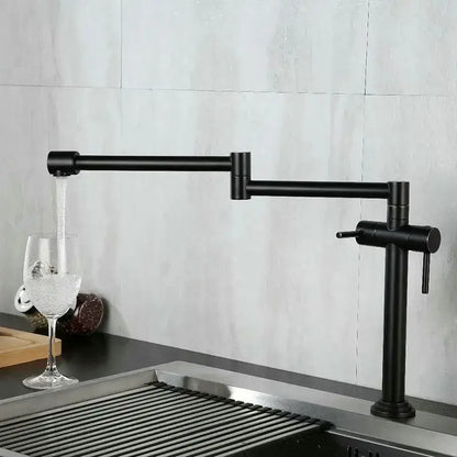 Modern brass single handle kitchen faucet with black matte finish and extendable articulated mixer tap design