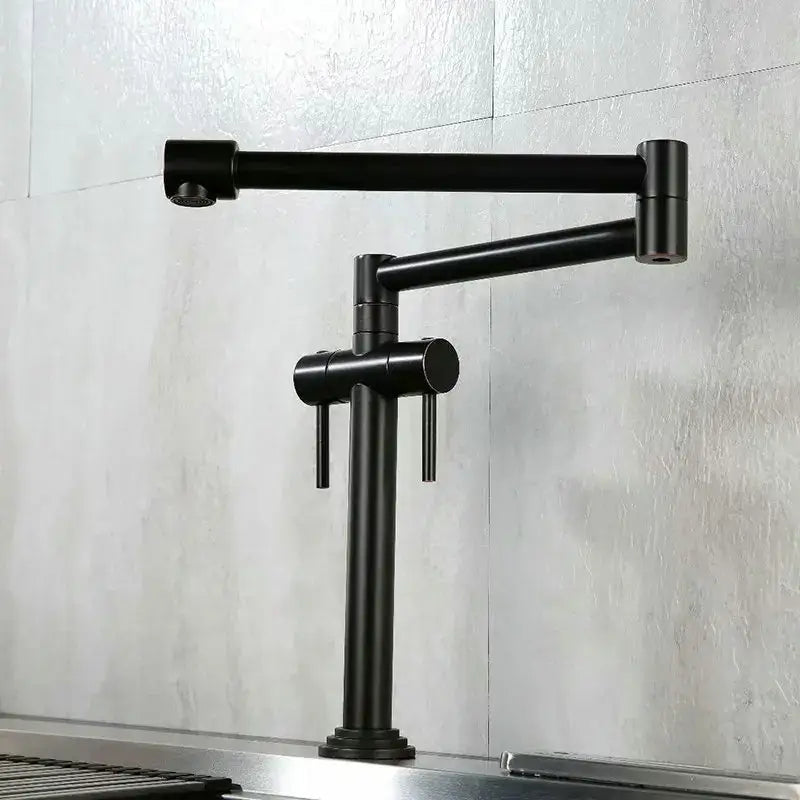 Black matte kitchen faucet with dual handles and articulated design paired with modern brass single handle mixer tap