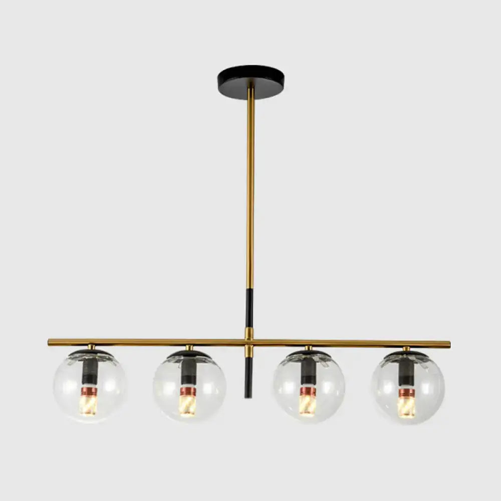 Modern brass and smoke grey globe chandelier with four clear glass bulbs for kitchen island lighting in white smoke grey