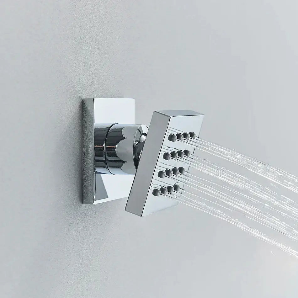 Modern brass square body spray shower jets with chrome-finished nozzles emitting water streams for bathroom massage