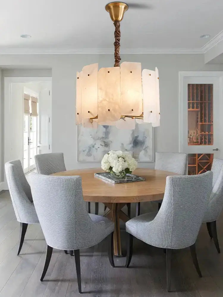 Modern brass stone pendant light with twisted chain and off-white marble panels for dining room decorbites brass stone