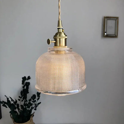 Modern brass textured glass led pendant light with a clear grid pattern and brass-finished hardware for kitchen use