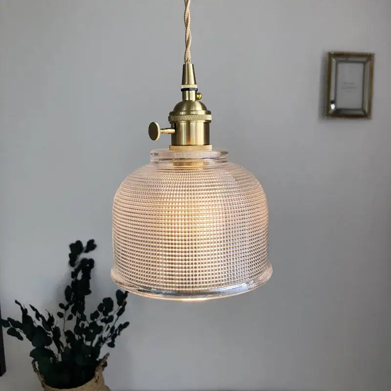Modern brass textured glass led pendant light with a clear grid pattern and brass-finished hardware for kitchen use