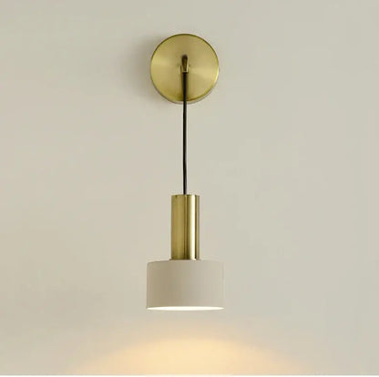 Modern brass wall lamp with cylindrical stem and white fabric shade ideal for minimalist living room decorbites brass wall lamp