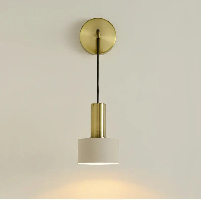 Modern brass wall lamp with cylindrical stem and white fabric shade ideal for minimalist living room decorbites brass wall lamp