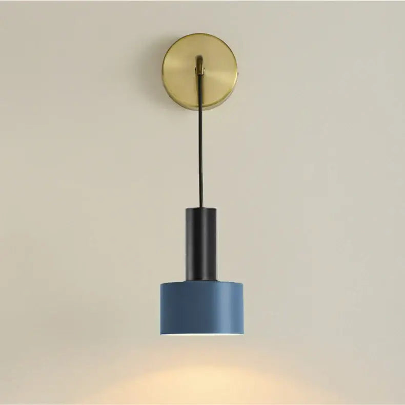 Modern brass wall lamp with blue cylindrical pendant light, black cord, and minimalist decorbites brass wall design
