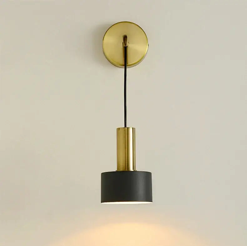 Modern brass wall lamp featuring a gold-toned cylindrical sconce with a matte black shade for minimalist decorbites brass wall lamp design