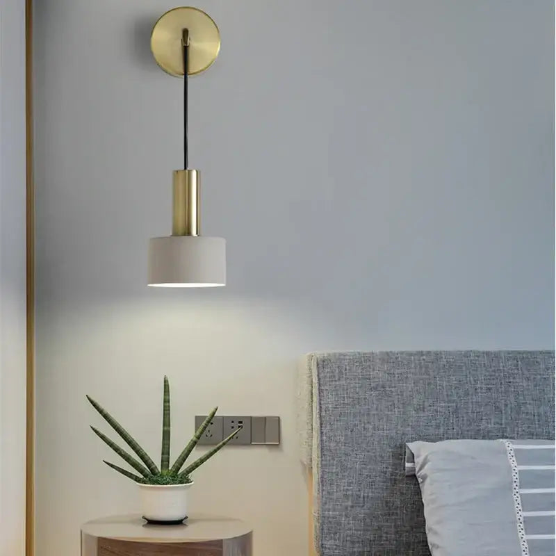 Modern brass wall lamp with gold-toned cylindrical pendant and matte white fabric shade for minimalist decorbites brass wall lamp
