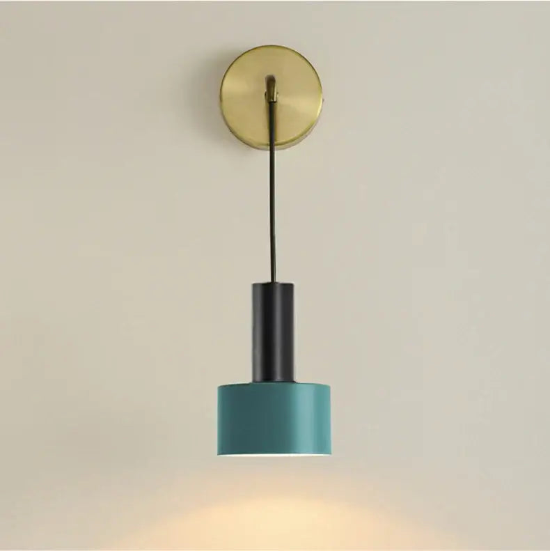 Modern teal cylindrical wall lamp with a brass wall mount and black central rod for minimalist living room decorbites brass wall lamp