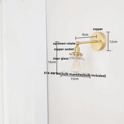 A modern brass wall lamp with clear glass shade and brass-finished copper for bedroom reading light decorbites clear glass