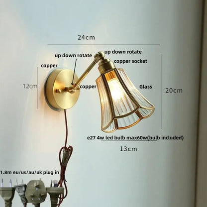 Modern brass wall lamp with brass finish, adjustable arm, copper socket, and clear glass fluted shade for reading light