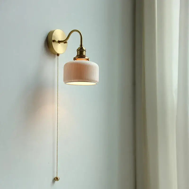 Modern brass wall lamp with ribbed soft pink ceramic shade and decorbites copper arm for bedroom reading light decor