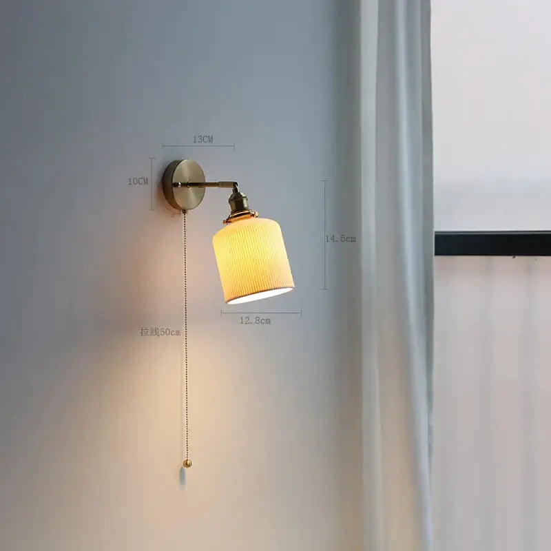 Modern brass wall lamp with ribbed warm-toned fabric shade and adjustable pull chain for bedroom reading light decorbites copper arm wall