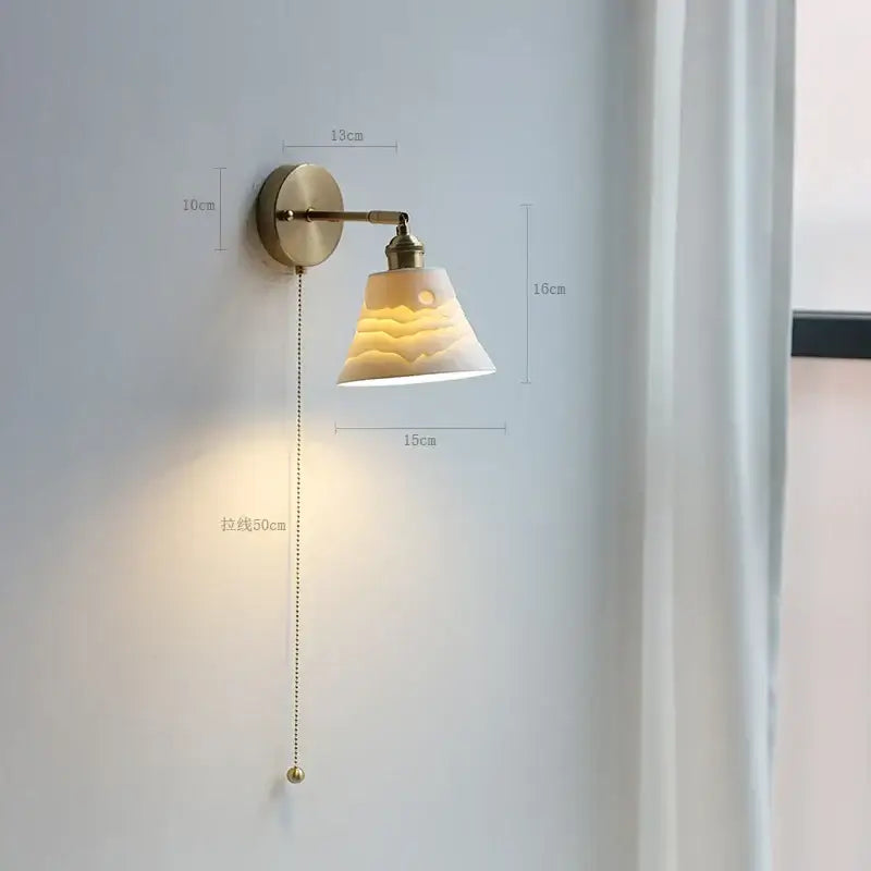 Modern brass wall lamp with vintage-style brass arm and cream ceramic shade featuring mountain and moon relief for bedroom decorbites copper arm wall