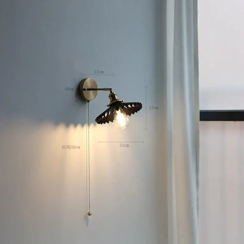 Modern brass wall lamp with antique brass finish copper arm wall sconce winged design and exposed bulb for bedroom reading light