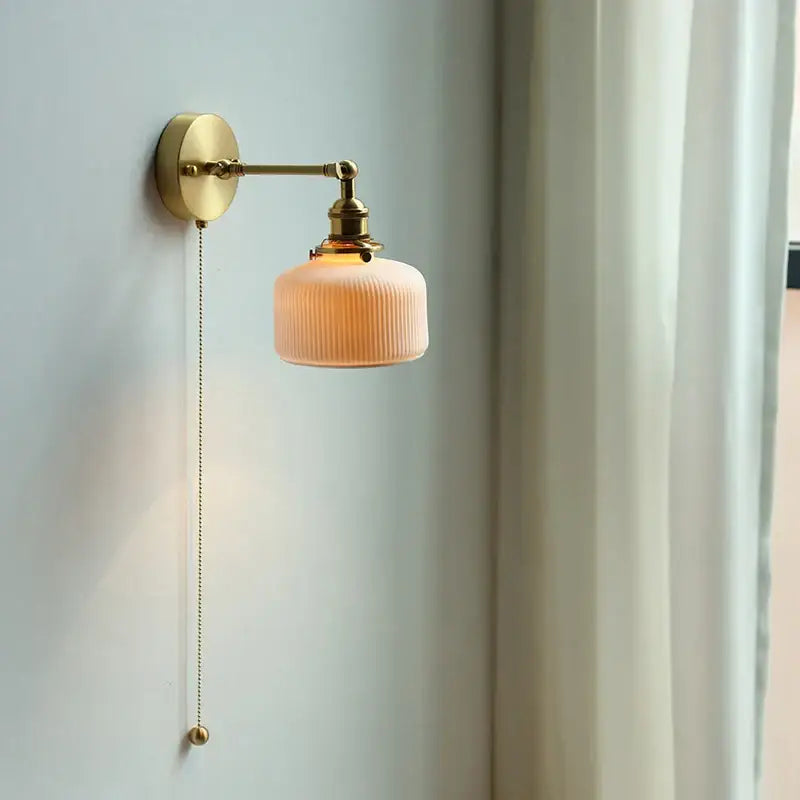 Modern brass wall lamp with ribbed peach glass shade and copper arm wall design for bedroom reading light decorbites copper arm