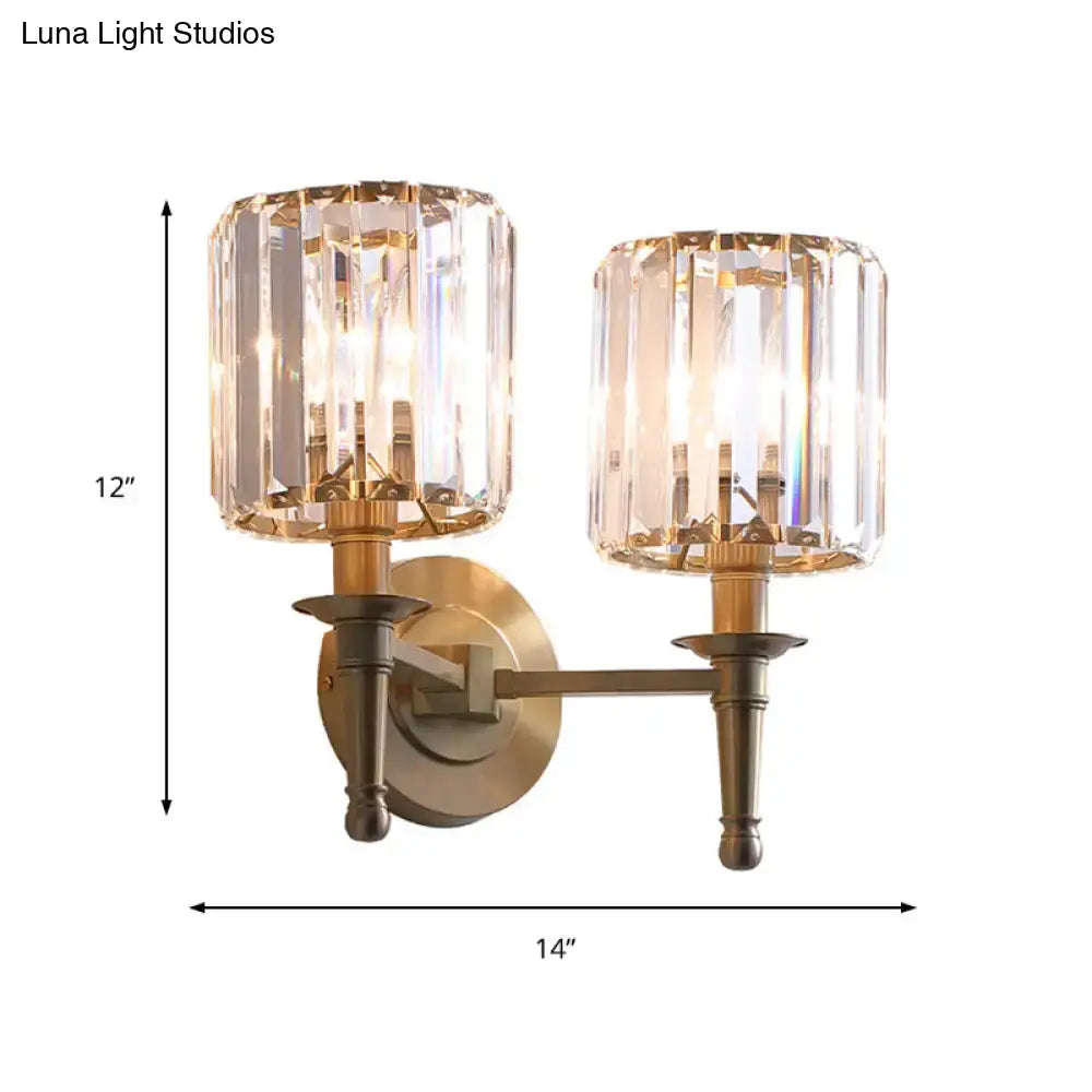 Modern brass wall light sconce with two faceted crystal shades for bedroom featuring elegant wall lamp design